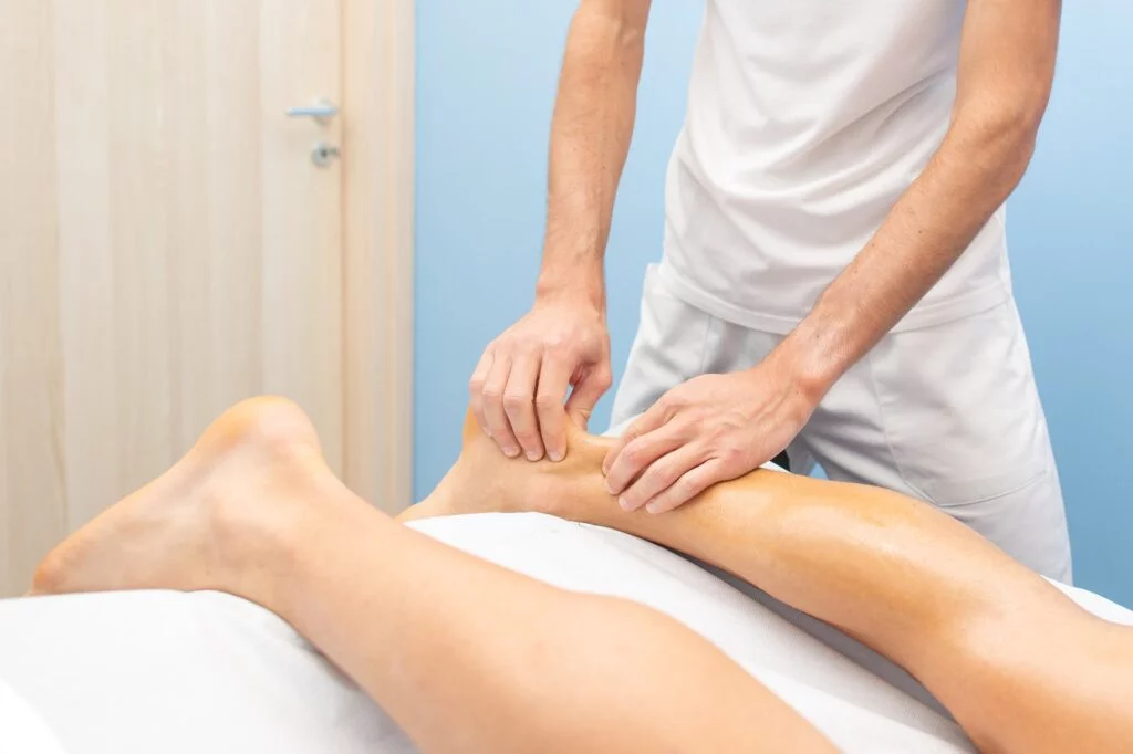 Doctor performing an Achilles tendon examination on a patient