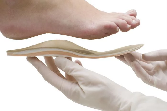 Custom orthotic being fitted to a patient's foot
