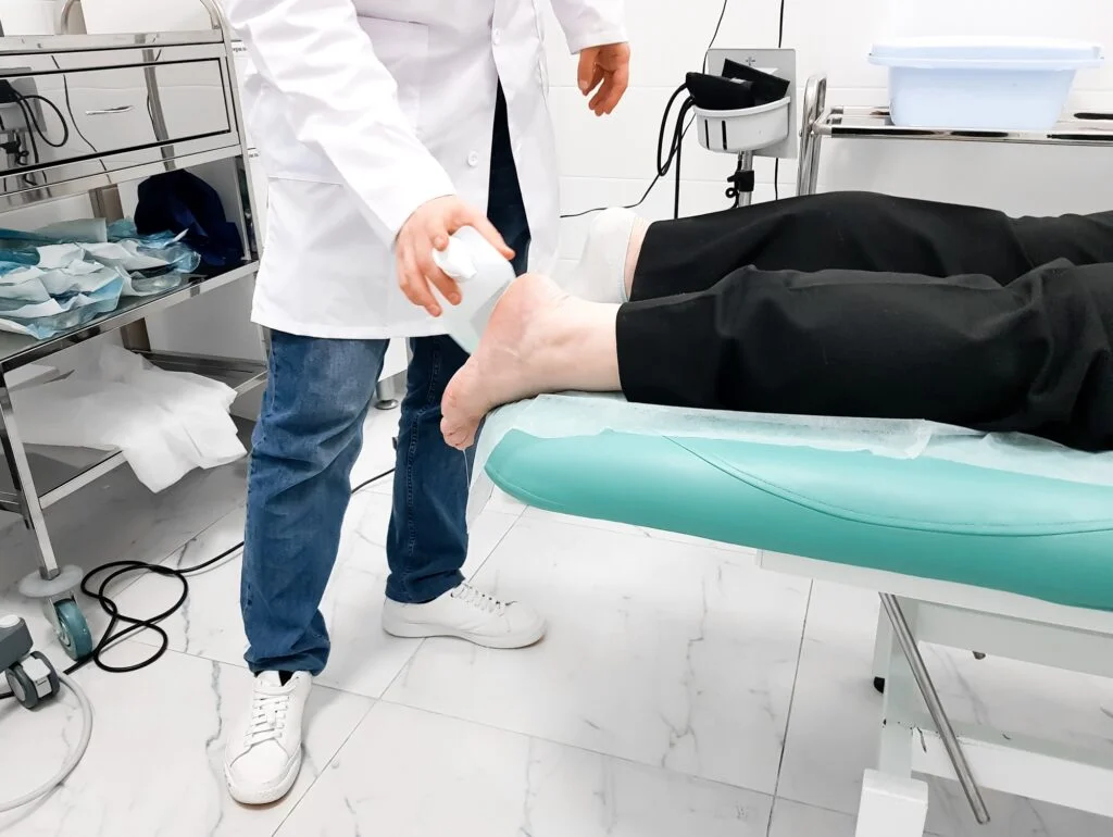 Doctor permorming Shockware Therapy on patient