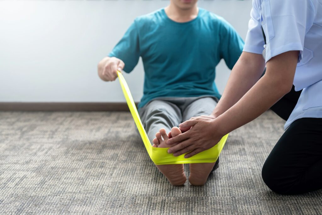 Doctor helping patient with physical therapy