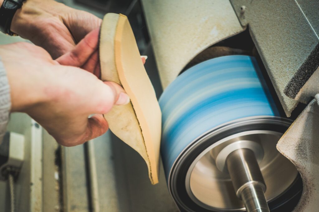 Orthotic being finished on a grinding machine